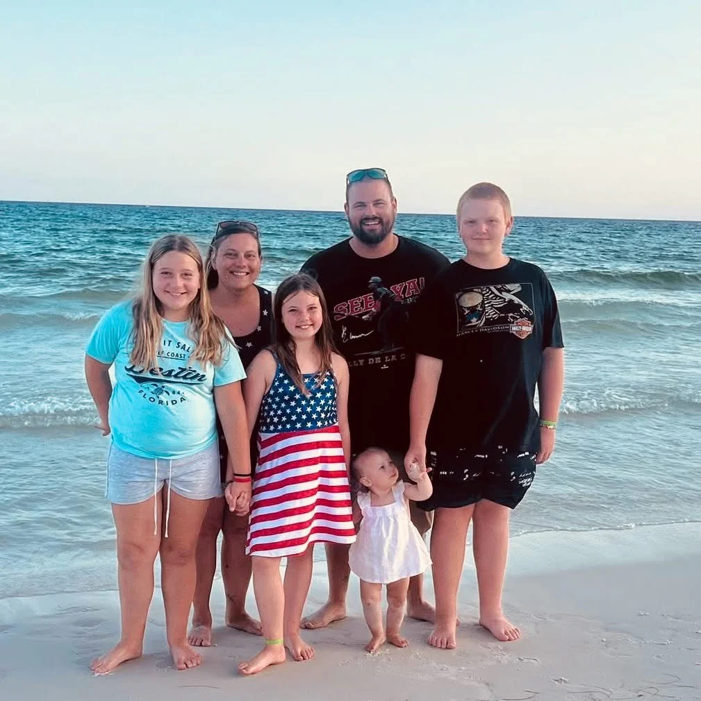 Remington standing with a group at the beach